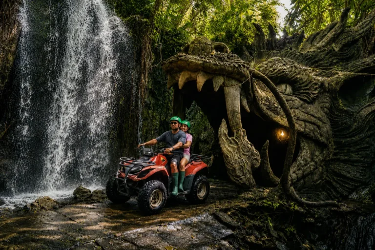 Green ATV Bali adventure with waterfall, jungle, river, and muddy trail